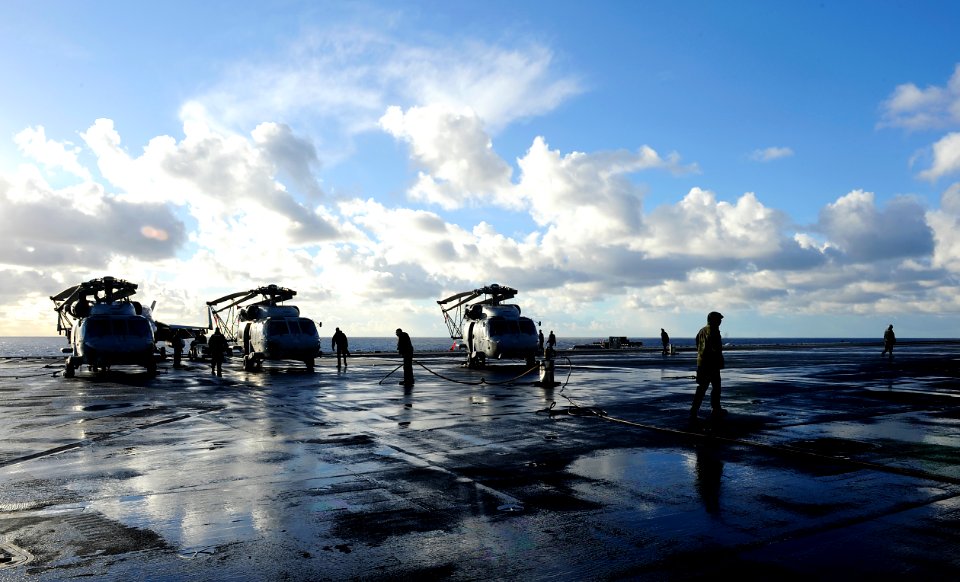 US Navy 101214-B-3793B-045 Sailors assigned to the air department wash the pad-eyes on the flight deck aboard the aircraft carrier USS Harry S. Tru