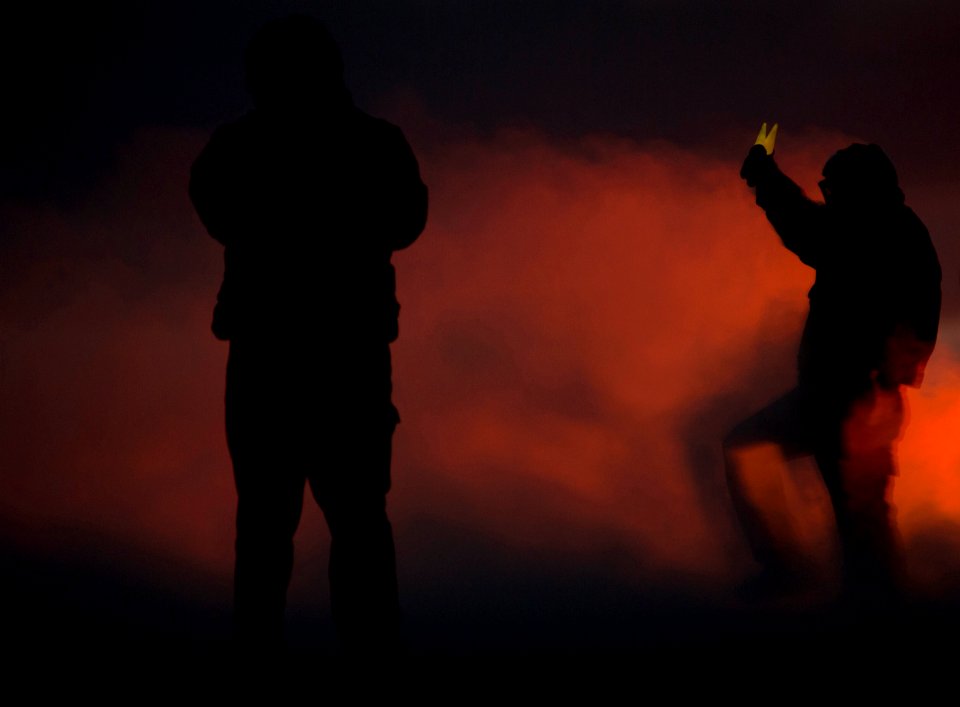 US Navy 101215-N-7981E-515 An aircraft director guides an F-A-18C Hornet onto a steam-powered catapult at dusk on the flight deck of the aircraft c