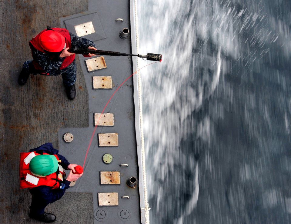 US Navy 101214-N-6006S-048 A Sailor aboard the guided-missile cruiser USS Bunker Hill (CG 52) fires a shot line