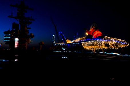 US Navy 101219-N-6632S-012 An F-A-18 Hornet is decorated with Christmas lights on the flight deck of the aircraft carrier USS George H.W. Bush (CVN photo