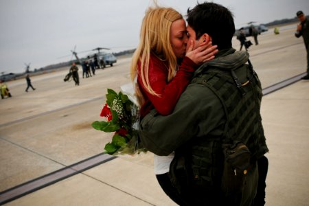 US Navy 101219-N-8590G-002 Aviation Warfare Technician 2nd Class Marc Bellon kisses his girlfriend during a homecoming celebration for the Dusty D