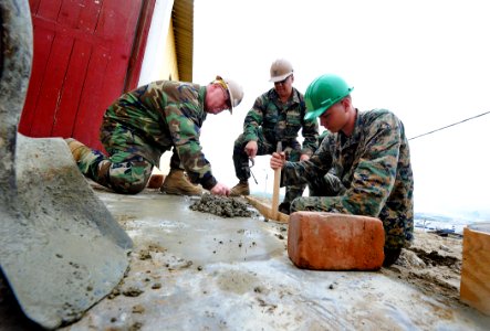 US Navy 101214-N-7589W-060 Equipment Operator 1st Class Jimmy Peterson, left, Utilitiesman 1st Class Carlos Sanchez and Cpl. Paul Fuit