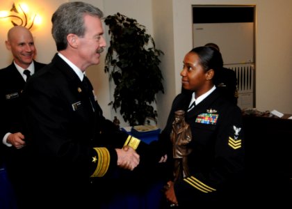 US Navy 101216-N-3283P-002 Rear Adm. Rick Wren apresents Yeoman 1st Class Nashera Brown the Sailor of the Year during a luncheon at Fleet Activitie