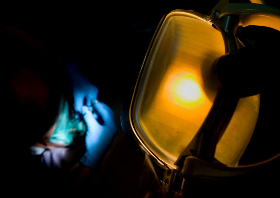 US Navy 101220-N-2055M-148 Lt. Cmdr. Steve Stallings fills a Sailor's tooth aboard the aircraft carrier USS Carl Vinson (CVN 70)