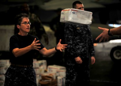 US Navy 101216-N-5016P-082 Master Chief Susan Whitman, command master chief aboard the aircraft carrier USS Abraham Lincoln (CVN 72), helps the shi