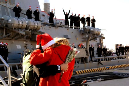 US Navy 101220-N-5292M-534 Gas Turbine System Technician (Mechanical) 2nd Class Matthew Mosely receives the traditional first kiss from his wife du