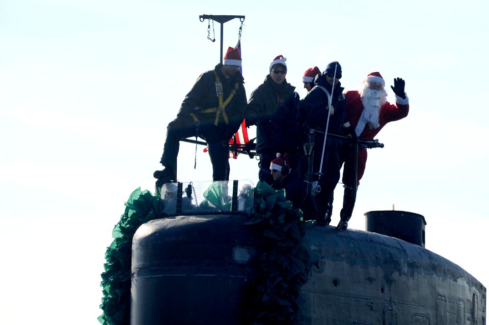 US Navy 101218-N-8467N-001 Santa Claus waves from the sail of the Los Angeles-class attack submarine USS Alexandria (SSN 757)