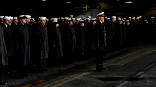 US Navy 101220-N-6427M-034 Sailors stand at attention in the hangar deck as the aircraft carrier USS Harry S. Truman (CVN 75) pulls into homeport a
