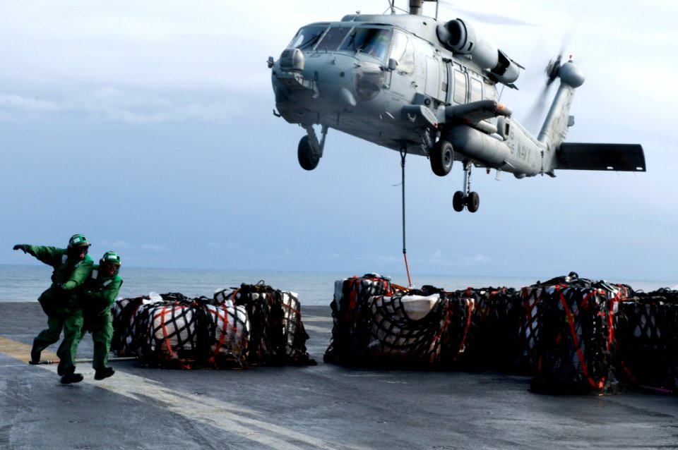 US Navy 101221-N-2953W-384 Sailors assigned to the supply department aboard the aircraft carrier USS Carl Vinson (CVN 70) run to safety