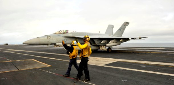 US Navy 101217-N-2953W-138 Sailors signal an F-A-18E Super Hornet on the flight deck aboard the aircraft carrier USS Carl Vinson (CVN 70)