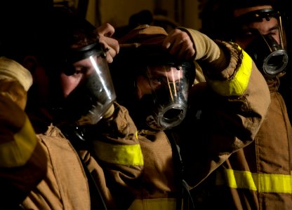 US Navy 101219-N-7981E-504 Aviation Electrician's Mate Airman Jamie Fisher, center, and other Sailors assigned to repair locker 1F
