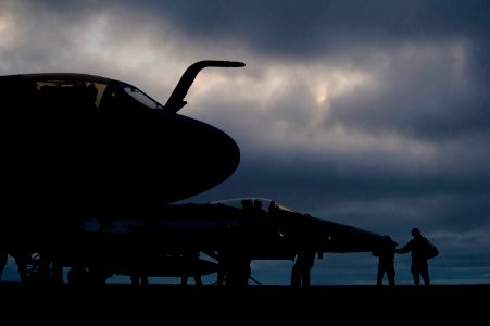 US Navy 101215-N-7981E-604 An EA-6B Prowler and an F-A-18C Hornet are readied for launch after sunset aboard the aircraft carrier USS Carl Vinson (