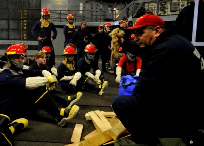 US Navy 101216-N-2147L-001 enior Chief Damage Controlman Frank Ferrantelli conducts pipe patching training during a flooding drill aboard USS New Y