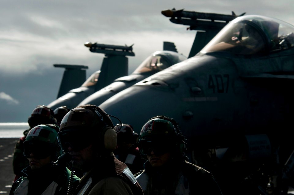 US Navy 101217-N-7981E-203 Squadron maintenance personnel monitor the launch of their aircraft as others are readied for missions on the flight dec
