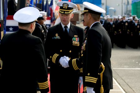 US Navy 101217-N-5758H-067 Capt. William T. Wagner, left, and Cmdr. H.B. Le, right, congratulate Cmdr. Walter C. Wrye IV as the new commanding offi