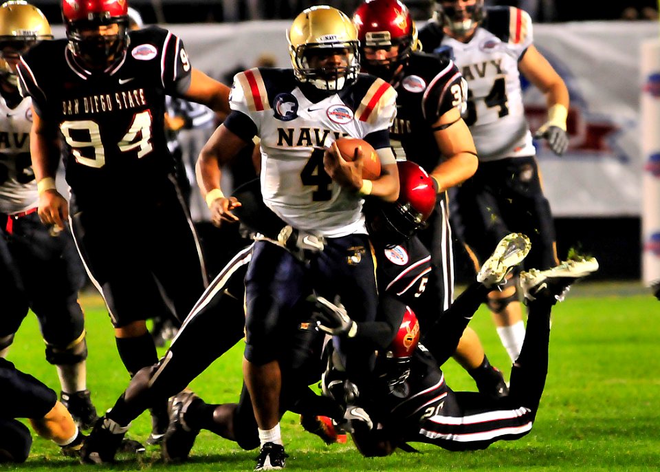 US Navy 101223-N-1722W-182 U.S. Naval Academy quarterback Ricky Dobbs (^4), tries to get past San Diego State University defenders during the 2010