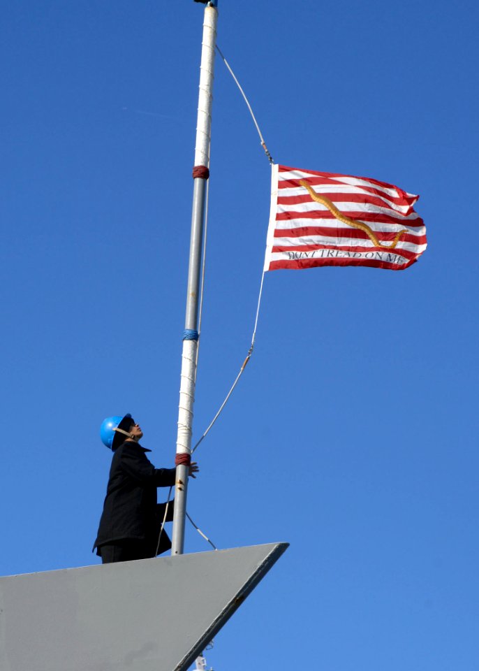 US Navy 101223-N-5292M-095 A Sailor hoists the Navy jack aboard the guided-missile frigate USS Kauffman (FFG 59) as the ship returns to Naval Stati
