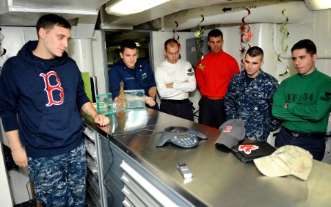 US Navy 101221-N-2821G-004 Sailors aboard the the aircraft carrier USS Abraham Lincoln (CVN 72) gather around an intercom phone to speak with Bosto