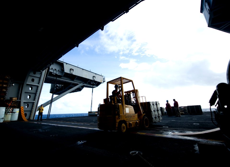 US Navy 101228-N-2055M-408 Sailors move crates of ordnance aboard USS Carl Vinson (CVN 70)