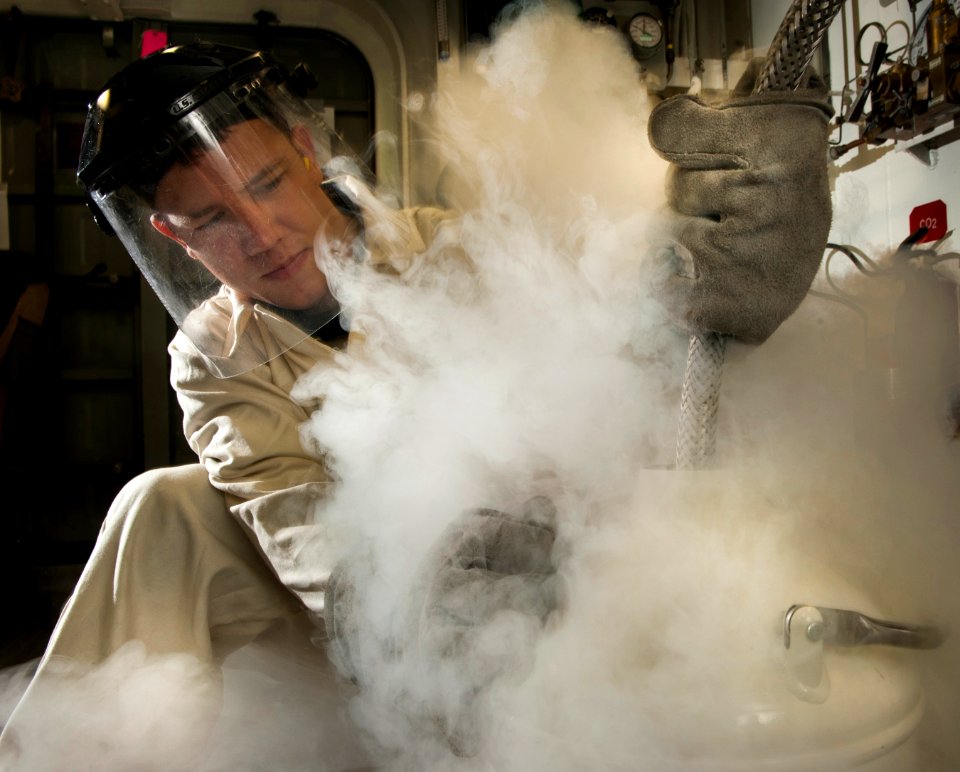 US Navy 101216-N-7981E-123 Machinist's Mate 3rd Class Tyrell Watkins, assigned to A division of the engineering department, fills a canister of liq