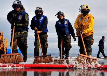 US Navy 101217-N-1722W-010 Sailors assigned to the amphibious assault ship USS Boxer (LHD 4) scrub the flight deck