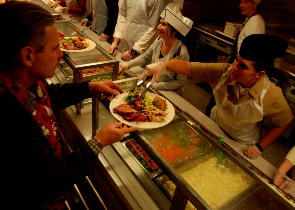 US Navy 101225-N-7642M-082 Gunner's Mate Seaman Kali Morris, assigned to USS Constitution, serves Christmas dinner at the New England Center for Ho