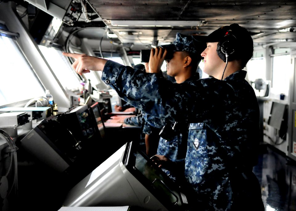 US Navy 101217-N-4590G-034 Operations Specialist 3rd Class Kyle Bullis stands watch on the bridge of USS Ronald Reagan (CVN 76)