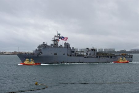 US Navy 101218-N-9643K-285 The amphibious dock landing ship USS Pearl Harbor (LSD 52) passes under the Coronado Bridge as the ship returns to Naval