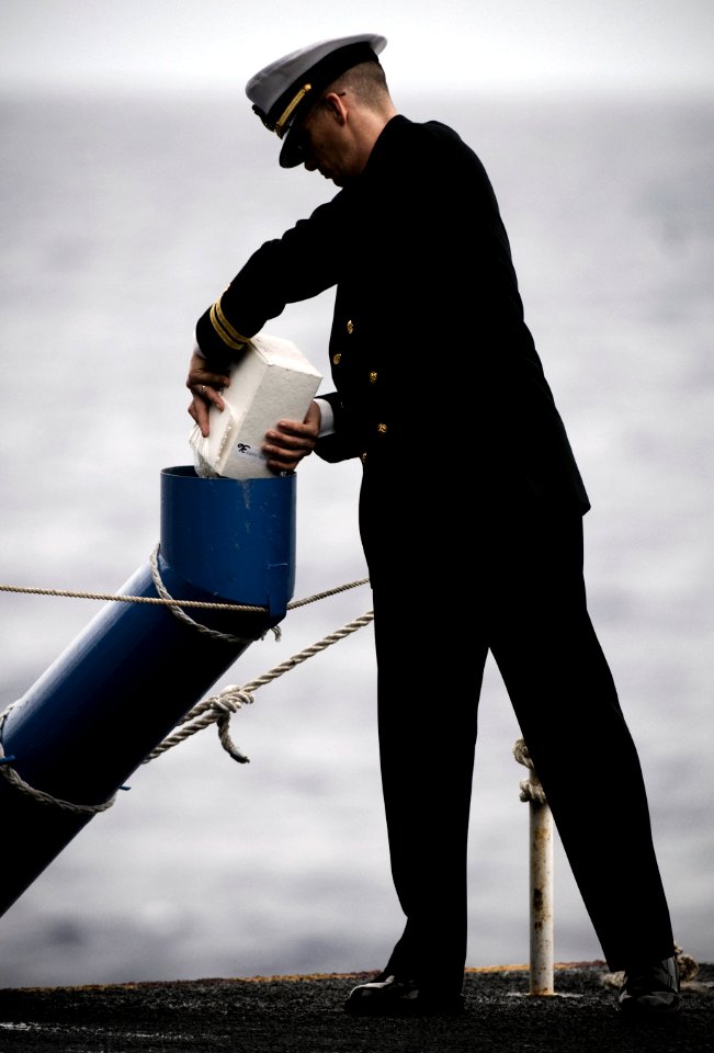US Navy 101227-N-2055M-606 Lt. Jeffreys Ross commits the ashes of a former service member to the ocean during a burial at sea