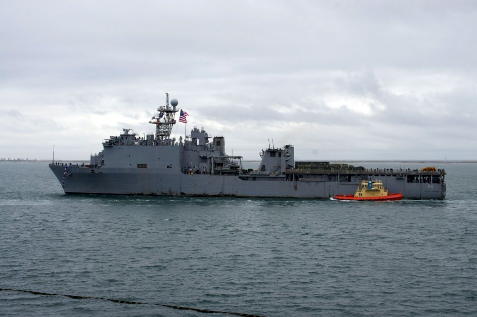 US Navy 101218-N-9643K-289 The amphibious dock landing ship USS Pearl Harbor (LSD 52) passes under the Coronado Bridge as the ship returns to Naval