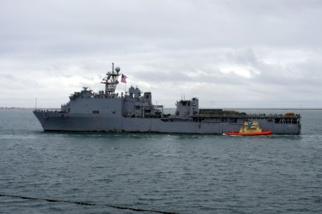 US Navy 101218-N-9643K-289 The amphibious dock landing ship USS Pearl Harbor (LSD 52) passes under the Coronado Bridge as the ship returns to Naval