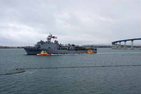 US Navy 101218-N-9643K-284 The amphibious dock landing ship USS Pearl Harbor (LSD 52) passes under the Coronado Bridge as the ship returns to Naval
