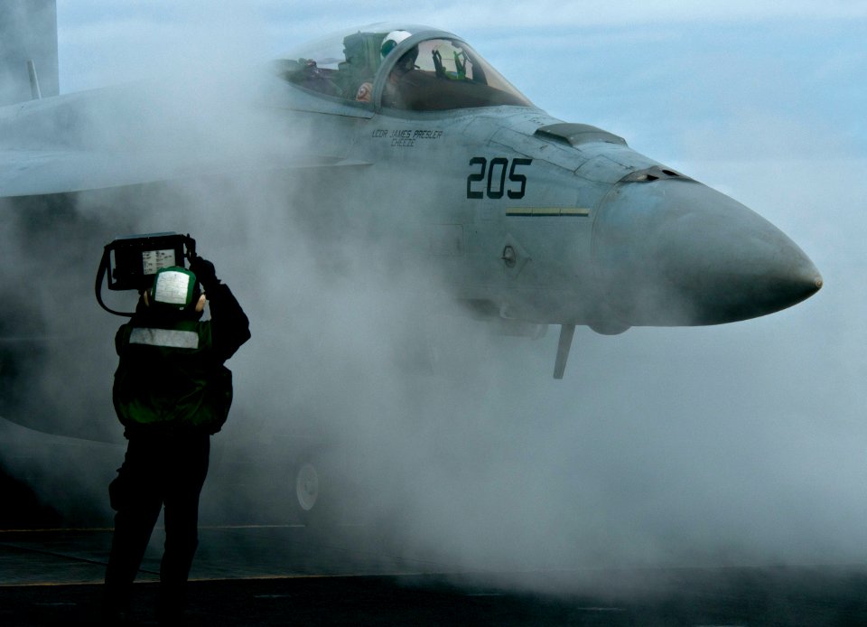 US Navy 101217-N-7981E-237 A Sailor displays the weight of an F-A-18E Super Hornet assigned to Strike Fighter Squadron (VFA) 81
