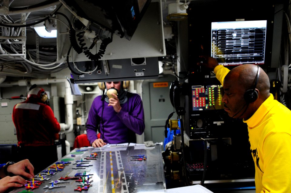 US Navy 101219-N-2953W-023 Lt. Cmdr. Tommy Edgeworth observes movements on the Ouija board during a simulated general quarters drill aboard USS Car