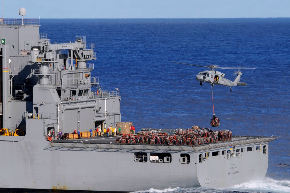 US Navy 101229-N-8040H-450 An MH-60S Sea Hawk helicopter assigned to Helicopter Sea Combat Squadron (HSC) 21 transports cargo from the Military Sea