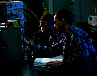US Navy 101218-N-7981E-101 Aviation Electronics Technician Airman Daniel Bammes, right, and Aviation Electronics Technician Airman Stouweed Innocen