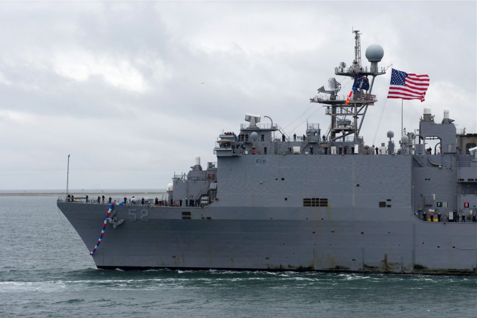 US Navy 101218-N-9643K-287 The amphibious dock landing ship USS Pearl Harbor (LSD 52) passes under the Coronado Bridge as the ship returns to Naval