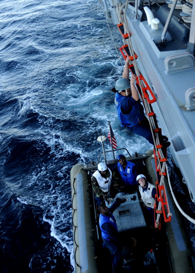 US Navy 110120-N-4322G-291 Boatswain's Mate Seaman Chyrel PoePoe climbs down a pilot's ladder from the guided-missile destroyer USS Sampson (DDG 10