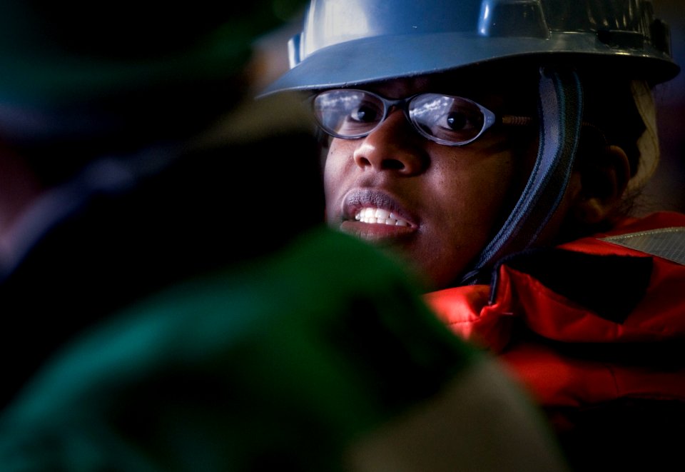 US Navy 101221-N-2055M-211 Boatswain's Mate Seaman Charlesa Anderson discusses signals to give to the Military Sealift Command fleet replenishment