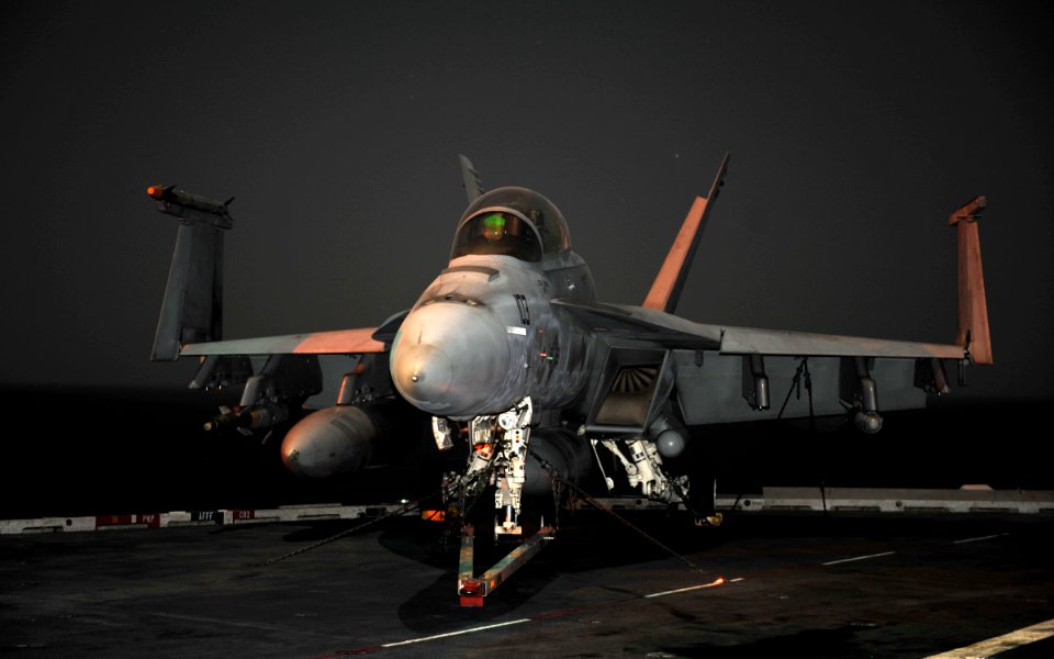 US Navy 101219-N-5016P-001 An F-A-18 Super Hornet is chained to the flight deck aboard USS Abraham Lincoln (CVN 72)