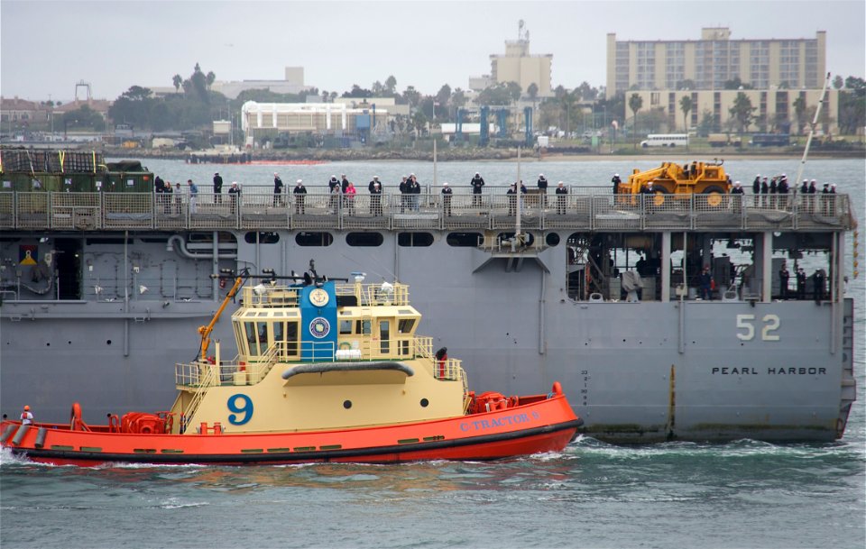 US Navy 101218-N-9643K-288 The amphibious dock landing ship USS Pearl Harbor (LSD 52) passes under the Coronado Bridge as the ship returns to Naval