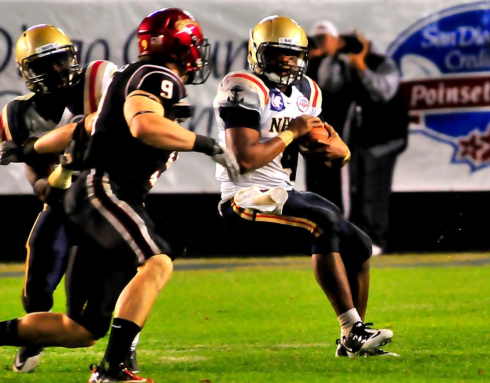 US Navy 101223-N-1722W-168 U.S. Naval Academy quarterback Ricky Dobbs (^4), tries to get past San Diego State University linebacker Miles Burris (