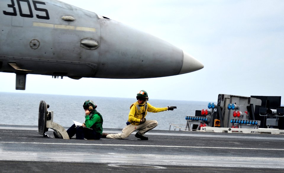 US Navy 110123-N-4973M-118 Lt. Cmdr. Jessica Parker, from St. Louis, signals the launch of an F-A-18C Hornet assigned to the Vigilantes of Strike F