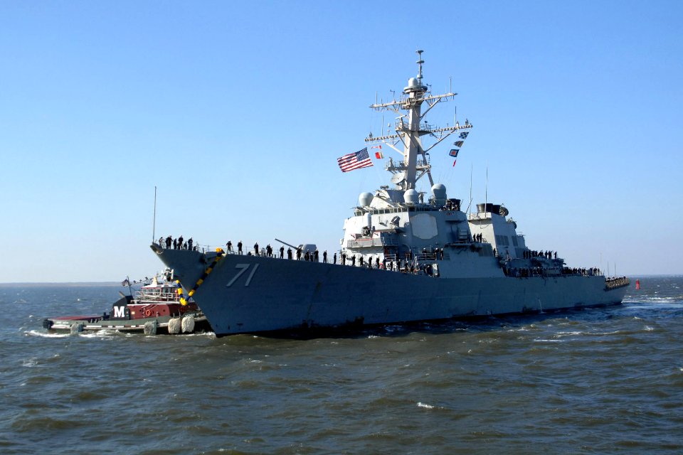 US Navy 101220-N-5292M-418 A Tug boat guides the guided-missile destroyer USS Ross (DDG 71) to the pier as the ship returns to Naval Station Norfol