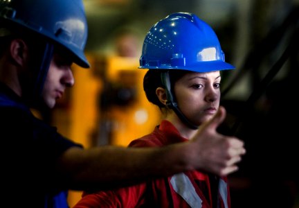 US Navy 101221-N-2055M-121 Aviation Ordnanceman Airman Angelica Medved watches stores being delivered from the Military Sealift Command fleet reple