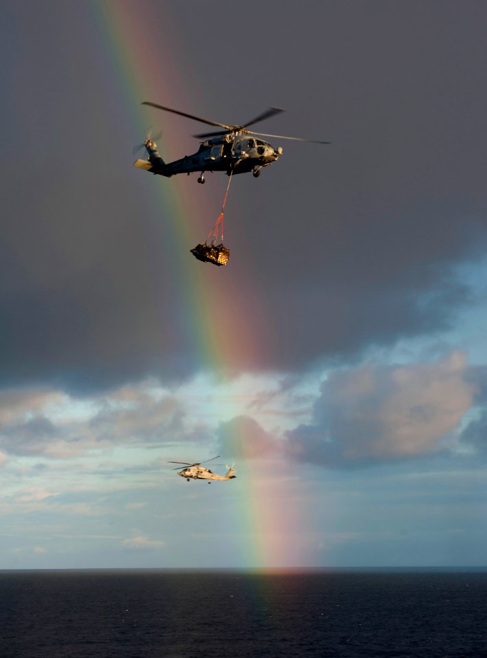 US Navy 101224-N-7981E-252 HH-60H Sea Hawk helicopters assigned to Helicopter Anti-Submarine Squadron (HS) 15 pass a rainbow while delivering mail