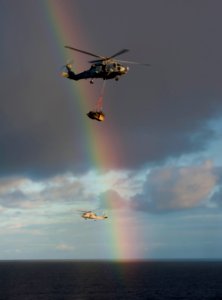 US Navy 101224-N-7981E-252 HH-60H Sea Hawk helicopters assigned to Helicopter Anti-Submarine Squadron (HS) 15 pass a rainbow while delivering mail