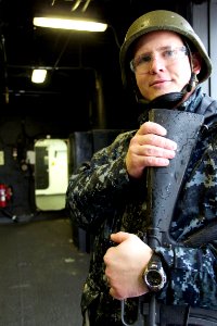 US Navy 101221-N-9643K-481 The roving security watch for the flight deck aboard the amphibious assault ship USS Bonhomme Richard (LHD 6) steps insi