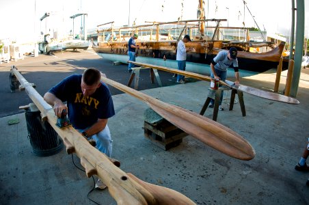 US Navy 110122-N-6674H-001 Sailors sand down pieces of a Polynesian canoe for the Polynesian Voyaging Society