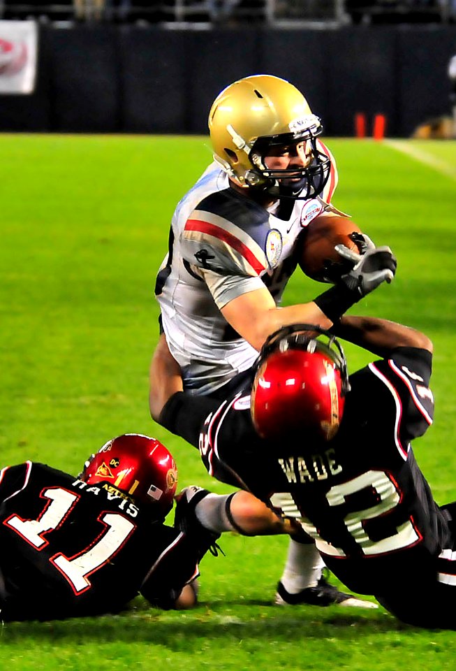 US Navy 101223-N-1722W-252 U.S. Naval Academy running back Bo Snelson (^23)is stopped by San Diego State University defensive backs Brandon Davis (